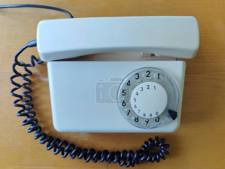 Photo for Top view of white old phone on office. Concept of obsolete technology - Royalty Free Image