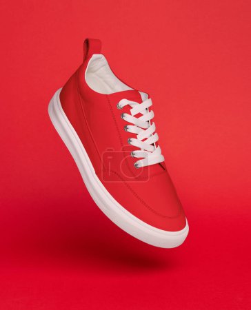 Photo for Red sneaker on a red background - Royalty Free Image