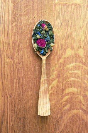 Photo for Tea in a wooden spoon on a wooden background - Royalty Free Image