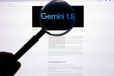 Téléchargez les photos : DALLAS, TX USA - 19 FÉVRIER 2024 : Une main tenant une loupe de verre sur Google Gemini 1.5 article. Google Gemini 1.5 est un modèle de langage développé par Google AI.. - en image libre de droit