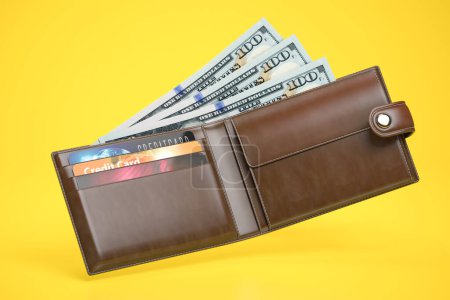 Photo for Open leather wallet with dollars and credit cards on yellow background. 3d illustration - Royalty Free Image