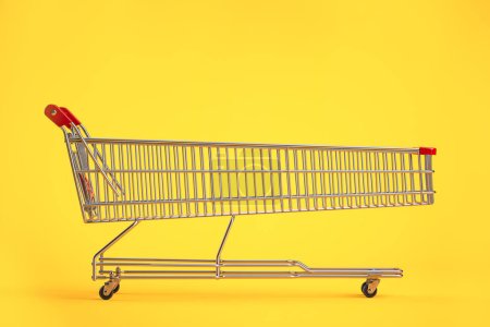 Photo for Long shopping cart on yellow background. Sales an discounts concept. 3d illustration - Royalty Free Image