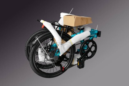 Folding bike in a package. Close-up. Isolated on a gray background.