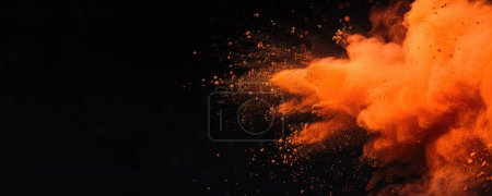 Holi Celebration Background - une vue rapprochée d'une substance orange vif, qui semble être une explosion de poussière dans les airs. L'explosion met en valeur une couleur orange vif, et les particules sont dispersées dans tout le cadre.