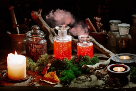 Foto de Brujería bodegón concepto de vida con poción para fumar, hierbas ingredientes velas y equipo mágico - Imagen libre de derechos