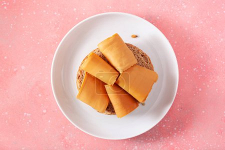 fresh bun with Norwegian brunost traditional brown cheese