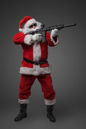 Photo for Studio shot of santa claus shooter with long beard aiming rifle. - Royalty Free Image