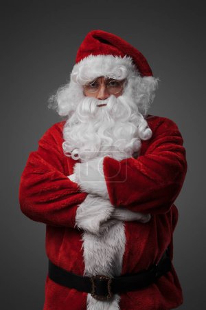 Photo for Portrait of isolated on grey santa dressed in red costume staring at camera. - Royalty Free Image