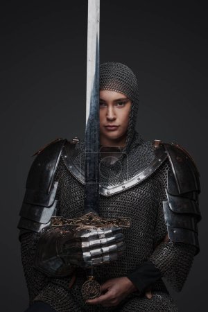 Photo for Photo of medieval knight woman holding sword dressed in chainmail. - Royalty Free Image