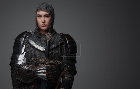 Photo for Studio shot of antique knight woman dressed in chainmail and armor. - Royalty Free Image