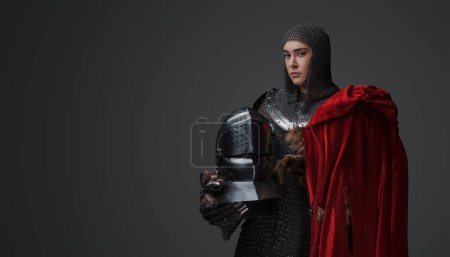 Photo for Studio portrait of determined female knight dressed in chainmail against grey background. - Royalty Free Image