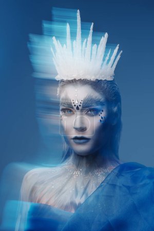 Photo for Studio portrait of snow queen with frozen skin and crown looking at camera. - Royalty Free Image