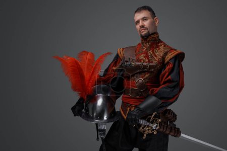 Photo for Shot of handsome musketeer man with beard dressed in stylish costume. - Royalty Free Image