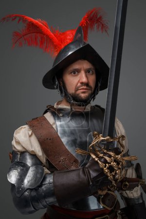 Photo for Studio shot of antique musketeer duelist with sword isolated on grey background. - Royalty Free Image