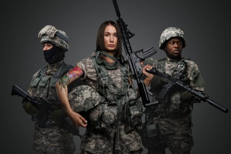 Photo for Shot of multiethnic squad of soldiers dressed in modern uniforms armed with rifles. - Royalty Free Image