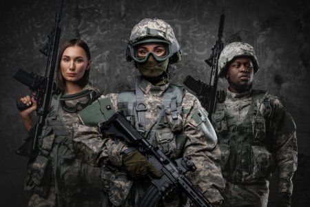Photo for Portrait of multiethnic group of soldiers dressed in camouflage uniforms holding rifles. - Royalty Free Image