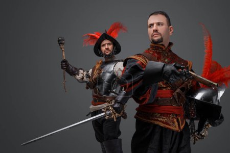 Foto de Portrait of isolated on gray background two conquistadors with pistol and torch. - Imagen libre de derechos