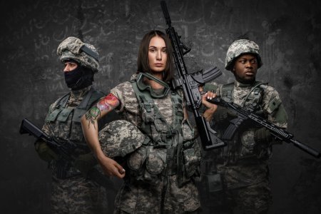 Photo for Shot of multiethnic squad of soldiers dressed in modern uniforms armed with rifles. - Royalty Free Image