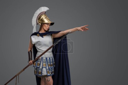 Photo for Shot of ancient female warlord from greece dressed in light armor and cloak. - Royalty Free Image