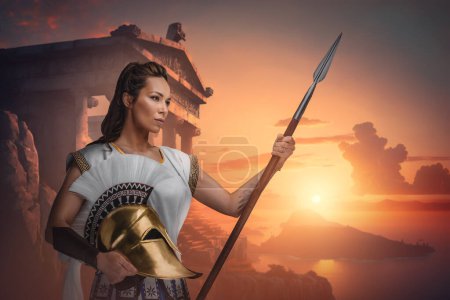Photo for Portrait of warrior woman dressed in white tunic holding spear. - Royalty Free Image