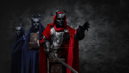 Photo for Studio shot of mysterious organization of three cultists dressed in robes and masks. - Royalty Free Image
