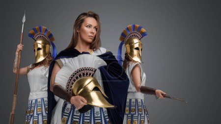 Photo for Portrait of three greek female warriors with spears and golden plumed helmets. - Royalty Free Image