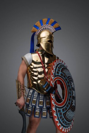 Téléchargez les photos : Studio shot of military man from ancient greece with shield and sword. - en image libre de droit