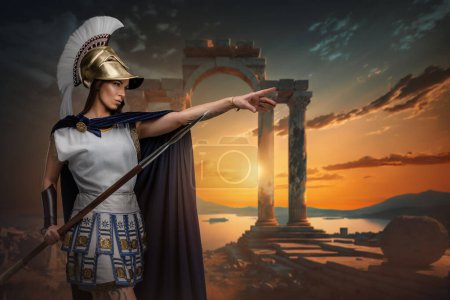 Photo for Portrait of warlike greek woman dressed in tunic and cloak holding long spear. - Royalty Free Image