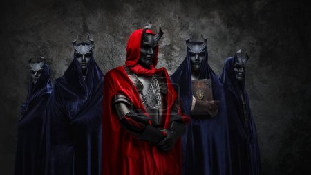Portrait of secret cult and its members dressed in robes and dark masks.