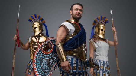 Photo for Portrait of greek troop of warlord and two warriors with bronze armors and spears. - Royalty Free Image