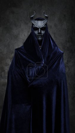 Foto de Studio shot of follower of dark cult dressed in dark robe and horned mask. - Imagen libre de derechos