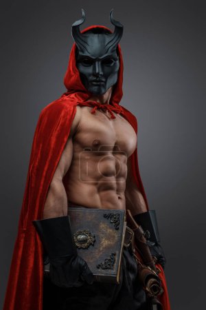 Photo for Shot of strong cultist of mystic cult in setting of dark fantasy against gray background. - Royalty Free Image