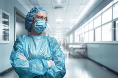 Photo for Shot of surgeon woman posing with crossed arms against corridor of modern hospital. - Royalty Free Image