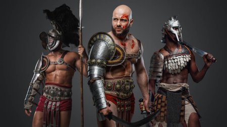 Photo for Studio shot of three warrior from ancient greece with muscular bodies. - Royalty Free Image