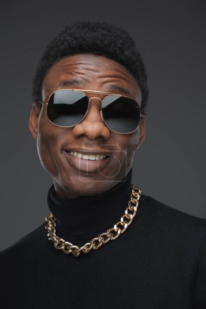 Photo for Studio shot of smiling black guy dressed in turtleneck sweater against grey background. - Royalty Free Image