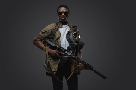 Photo for Studio shot of somali pirate man dressed in uniform posing agianst gray background. - Royalty Free Image
