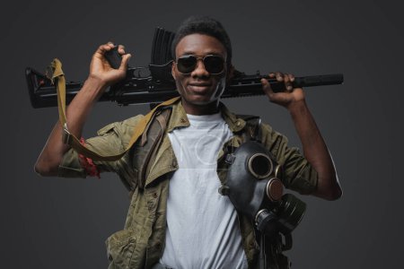 Photo for Portrait of handsome somali gangster holding rifle on his shoulders. - Royalty Free Image