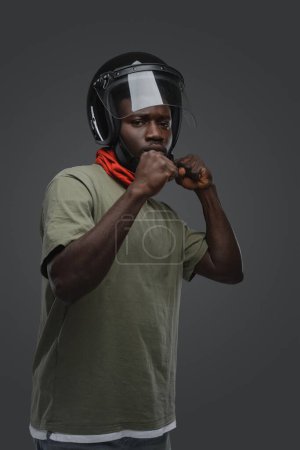 Photo for Shot of black guy dressed in casual clothes and protective helmet. - Royalty Free Image