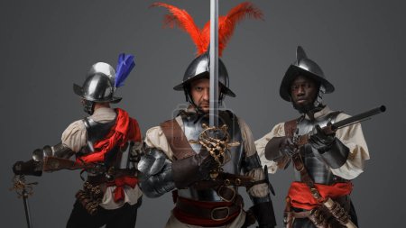 Photo for Shot of medieval conquistador staring at camera with two comrades on his sides. - Royalty Free Image