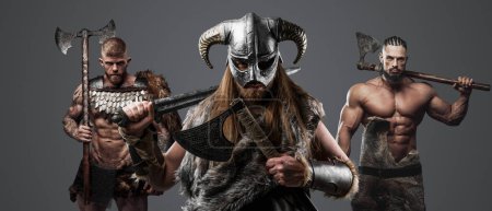 Photo for Shot of group of three barbaric vikings with armour and cold steel. - Royalty Free Image
