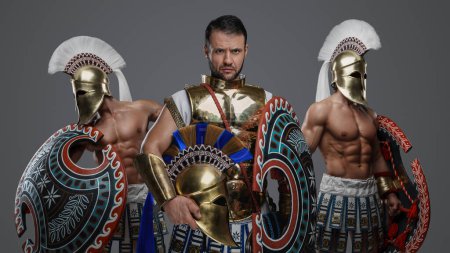 Photo for Portrait of ancient warlord fromt greece and two greek warriors with shields. - Royalty Free Image