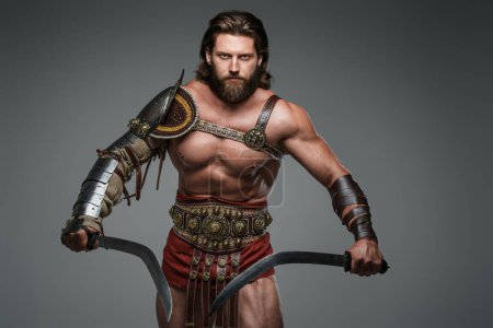 A fierce and imposing gladiator with long hair and a beard, donning light armor and standing tall with two swords. This warrior exudes strength and power against a neutral gray backdrop