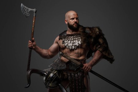 A bald, bearded Viking with a fierce appearance wearing fur and light armor, carrying a large axe, against a neutral backdrop