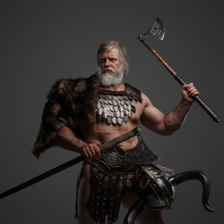 Grizzled elderly Viking warrior, displaying strength and wisdom, clad in furs and light armor, with a helmet slung on his waist, brandishing dual axes on a neutral background