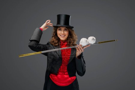 Photo for Mystical performance, female magician and white doves on gray background - Royalty Free Image