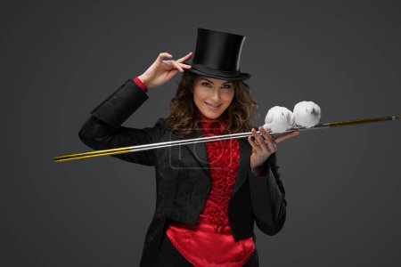 Photo for Mystical performance, female magician and white doves on gray background - Royalty Free Image