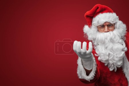 Photo for Jolly Santa Claus showing an okay gesture, assuring a merry Christmas - Royalty Free Image