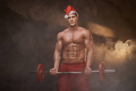 Photo for Santa Claus lifting weights, merging festive spirit with fitness goals - Royalty Free Image