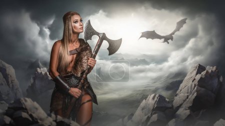Photo for A poised female warrior wields a decorative axe against a backdrop of mountains and a flying dragon under stormy skies - Royalty Free Image