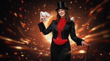 Photo for Captivating magician holding a wand with doves on a fiery background - Royalty Free Image